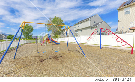 Panorama Whispy white clouds Small community playground near the fenced residential houses at Utah Valley Panorama Whispy white clouds Small community playground near the fenced residential houses at Utah Valley 89143424