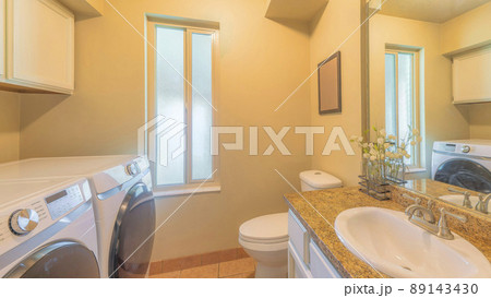 Panorama Small laundry and bathroom interior with narrow window Panorama Small laundry and bathroom interior with narrow window 89143430