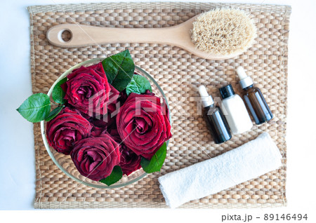 Flat lay organic, bio, natural cosmetics. Remedy for massage, spa. Roses , Natural oils and massage brush, blue clay Flat lay organic, bio, natural cosmetics. Remedy for massage, spa. Roses , Natural oils and massage brush, blue clay 89146494