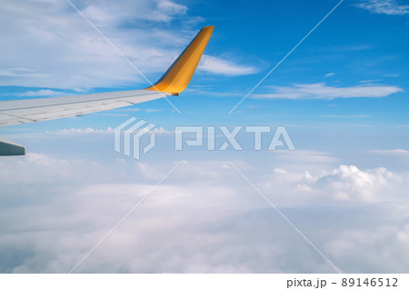 Blue sky and Clouds as seen through window of aircraft Blue sky and Clouds as seen through window of aircraft 89146512