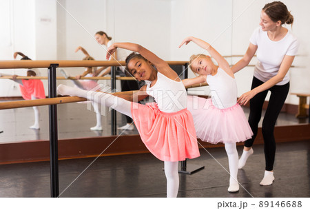 Ballet trainer teaching two little girls Ballet trainer teaching two little girls 89146688