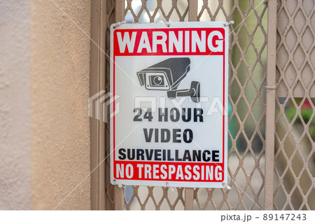Surveillance camera signage on a metal mesh wire railings at San Francisco, California Surveillance camera signage on a metal mesh wire railings at San Francisco, California 89147243