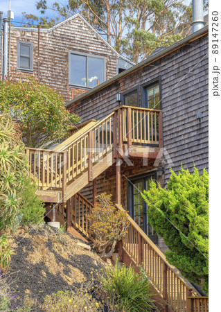 Wooden staircase of a house with landing on top of a slope at San Francisco, California 89147260