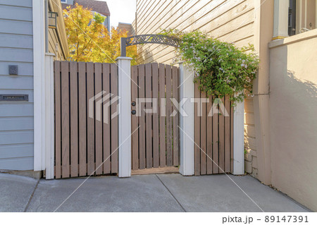 Wooden gate and fence with white concrete columns at San Francisco, California Wooden gate and fence with white concrete columns at San Francisco, California 89147391