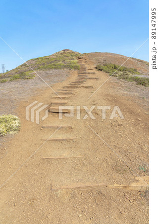 Mountain trail with wooden steps on the slope at the view from Twin Peaks in San Francisco, CA 89147995