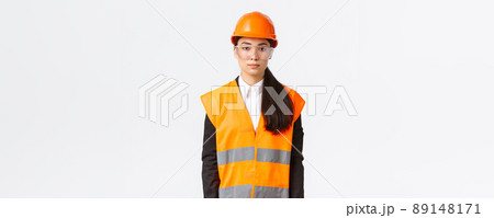 Serious-looking professional female asian construction engineer, architect at building area wearing uniform, safety helmet over business suit, standing white background, inspect enterprise Serious-looking professional female asian construction engineer, architect at building area wearing uniform, safety helmet over business suit, standing white background, inspect enterprise 89148171