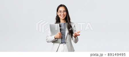 Business, finance and employment, female successful entrepreneurs concept. Smiling professional businesswoman, real estate broker showing clients good deal, carry laptop in hand 89149495
