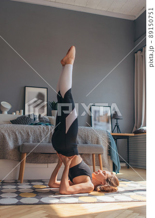 Stand on the shoulder blades. Fit woman working out at home Stand on the shoulder blades. Fit woman working out at home 89150751