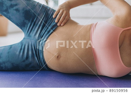 Prenatal Workout pregnant woman training glutes doing bridge floor