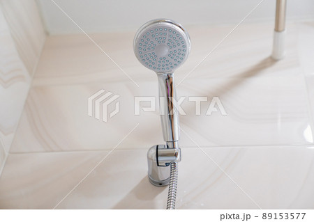 shower head in the bathroom. cleaning and maintenance of household appliances. shower head in the bathroom. cleaning and maintenance of household appliances. 89153577