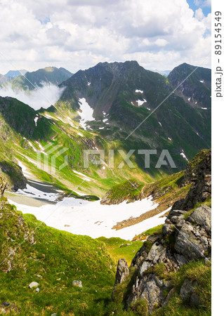 landscape of fagaras mountains in summer. beautiful nature scenery of romania. steep hills, grassy meadows and rocky peaks on a sunny day. popular travel destination 89154549