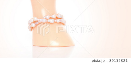 Double strand freshwater pearl bracelet on jewelry display stand. Collection of luxury jewelry accessories. Studio shot 89155321