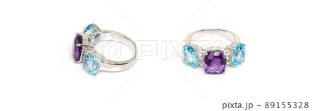 Amethyst with blue topaz and white sapphire Jewel or gems ring on white background. Collection of natural gemstones accessories. Studio shot Amethyst with blue topaz and white sapphire Jewel or gems ring on white background. Collection of natural gemstones accessories. Studio shot 89155328