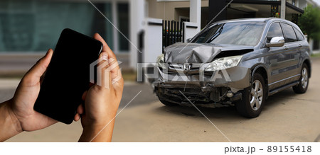 man holding smartphone and take photo of car accident call for help  damage to car after accident 89155418