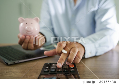 businessman working on desk office finance accounting saving money Piggy bank with business 89155430