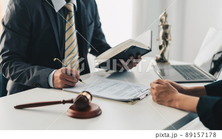 Businesswoman and lawyer adviser discuss the contract agreement document. Treaty of the law. sign a contract business concept. Businesswoman and lawyer adviser discuss the contract agreement document. Treaty of the law. sign a contract business concept. 89157178