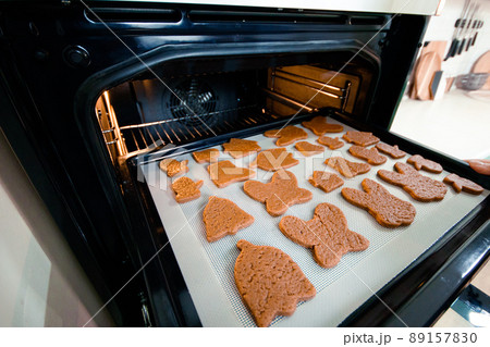 Baking sheet with raw cookies in front of the oven Baking sheet with raw cookies in front of the oven 89157830