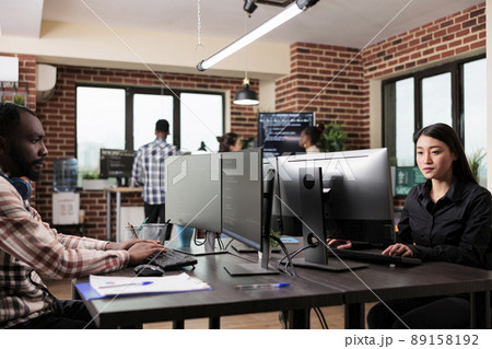 Software developer team programming encryption applications to be used as security measure. Diverse cybernetics engineers upgrading processing system application database. 89158192