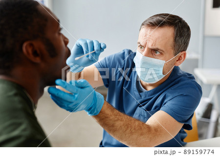 Doctor Taking Mouth Swab Doctor Taking Mouth Swab 89159774