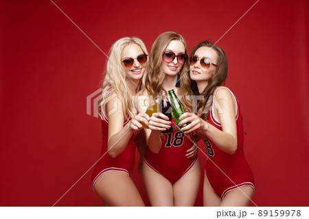Beautiful and happy female friends in bright red Beautiful and happy female friends in bright red 89159978