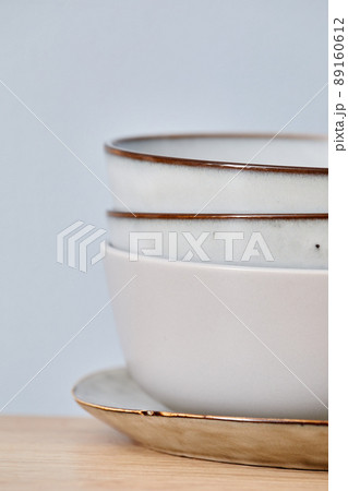 Stack of ceramic bowls on plate 89160612