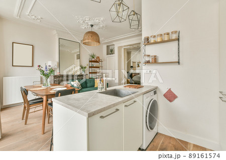 The rich interior of the living room of a modern house combined with a dining area kitchen The rich interior of the living room of a modern house combined with a dining area kitchen 89161574