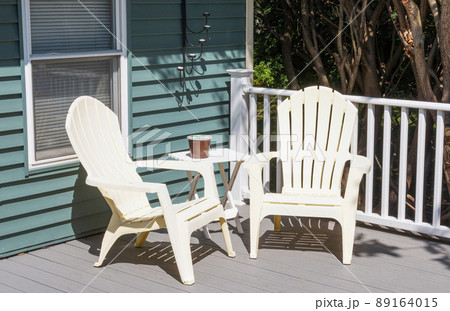 Two plastic chairs in the cornor of a new composite deck 89164015