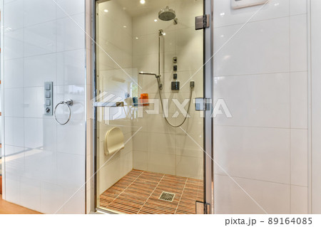 Expensive shower cabin with a glass door in a modern house 89164085