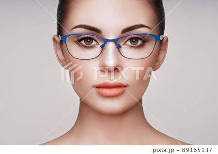 Woman with long eyelashes in eyeglasses 89165137