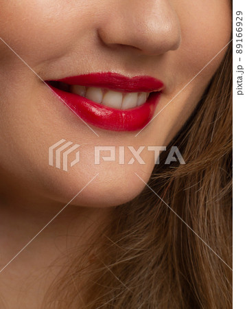 Close-up shot of sexy woman's lips with red lipstick and clean skin. Beautiful spa portrait with a snow-white smile. Spa and cosmetics, dentistry and cosmetology 89166929