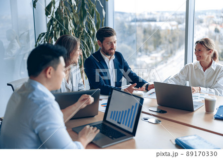 Creative business team working on project in modern office with panoramic view 89170330