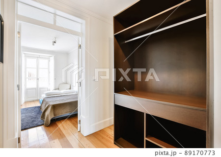Luxury room design with large black wooden wardrobe and wooden floor Luxury room design with large black wooden wardrobe and wooden floor 89170773