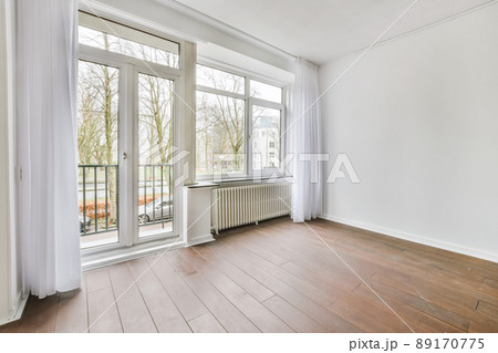 The interior of a stylish room with a window and curtains 89170775