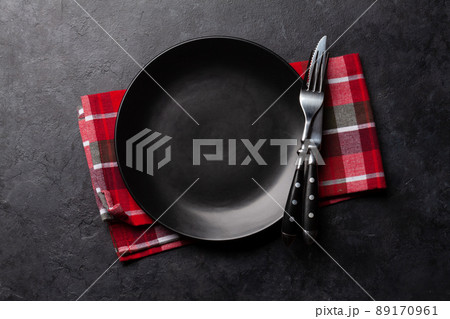 Empty plate and silverware on stone table 89170961