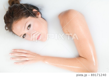 beautiful woman relaxing in milk bath beautiful woman relaxing in milk bath 89171240