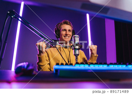 Cheerful gamer streamer just won esport multiplay competition 89171489