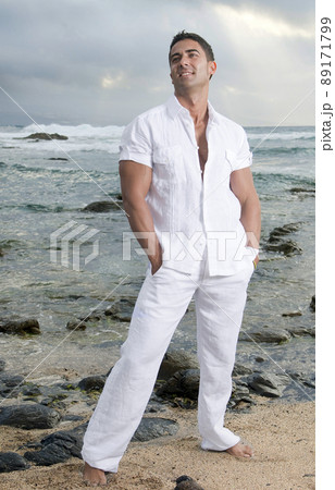 Beautiful man near the sea wearing white clothes Beautiful man near the sea wearing white clothes 89171799