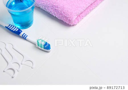 Dental hygiene. Toothbrush, mouthwash, pink towel, dental floss. 89172713
