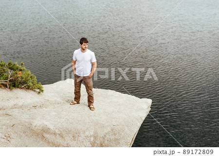 Traveler stands on a rock 89172809