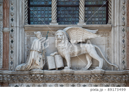 Winged Lion and a priest with a Bible at St. Mark's Square 89173499
