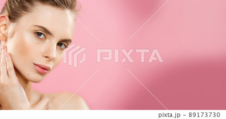 Beauty Concept - Beautiful Woman with Clean Fresh Skin close up on pink studio. Skin care face. Cosmetology. Beauty Concept - Beautiful Woman with Clean Fresh Skin close up on pink studio. Skin care face. Cosmetology. 89173730