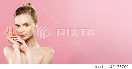 Beauty Concept - Beautiful Caucasian woman with clean skin, natural make-up isolated on bright pink background with copy space. 89173766