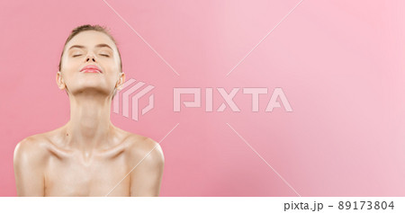 Beauty Concept - Beautiful Woman with Clean Fresh Skin close up on pink studio. Skin care face. Cosmetology. 89173804