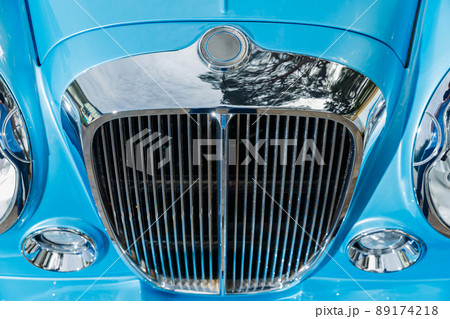 Close up view of chrome grille of exclusive vintage car, replica on the famous convertible car in French Riviera, Cap Ferrat, retro type, blue color, roadster, cote dazur Close up view of chrome grille of exclusive vintage car, replica on the famous convertible car in French Riviera, Cap Ferrat, retro type, blue color, roadster, cote dazur 89174218