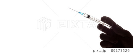 Hand holding syringe with vaccine against corona virus. Hand holding syringe with vaccine against corona virus. 89175526