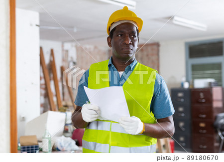 Responsible engineer with papers conducting inspection of construction site 89180670