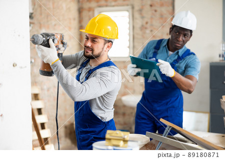Confident builder posing on indoor construction site Confident builder posing on indoor construction site 89180871