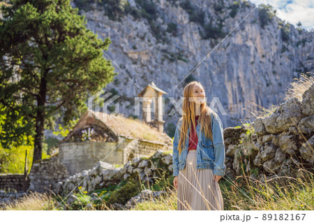 Woman tourist enjoys the view of Kotor. Montenegro. Bay of Kotor, Gulf of Kotor, Boka Kotorska and walled old city. Travel to Montenegro concept. Fortifications of Kotor is on UNESCO World Heritage Woman tourist enjoys the view of Kotor. Montenegro. Bay of Kotor, Gulf of Kotor, Boka Kotorska and walled old city. Travel to Montenegro concept. Fortifications of Kotor is on UNESCO World Heritage 89182167