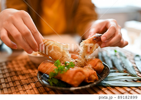 Close-up image, Asian woman eating fried spring rolls 89182899