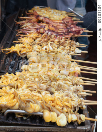 Grilled squid on skewers grilled over charcoal Grilled squid on skewers grilled over charcoal 89183184